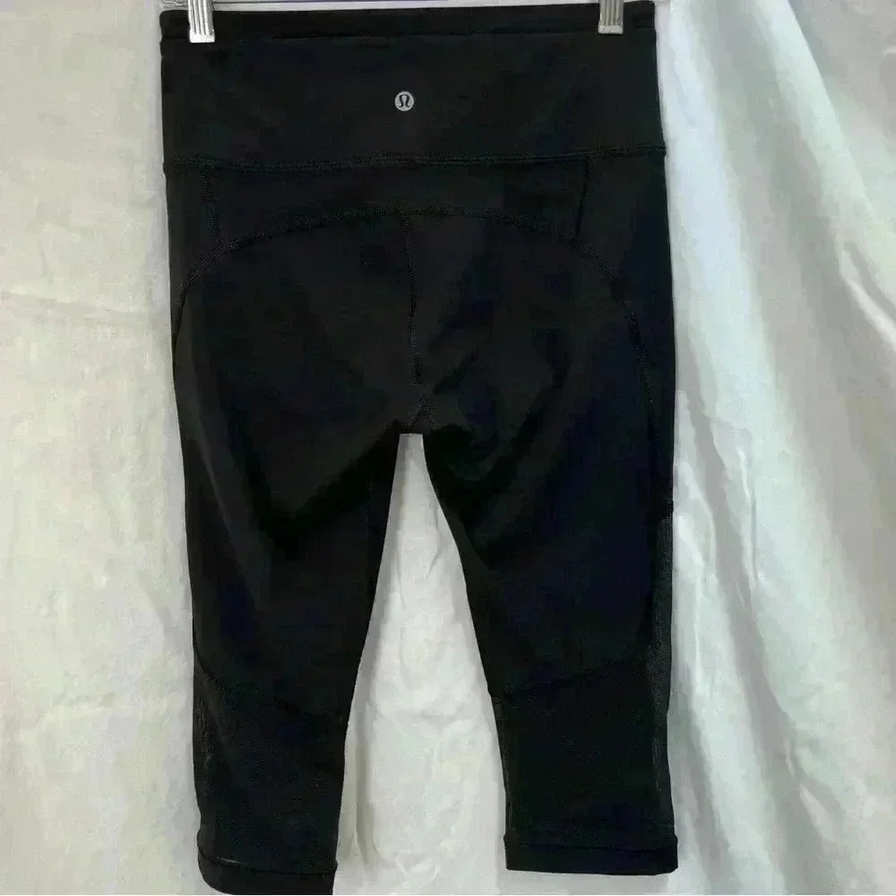 Lululemon cropped black leggings with mesh detailing.